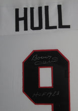 Load image into Gallery viewer, Chicago Blackhawks Bobby Hull Signed Jersey with HOF 1983 Inscription Framed &amp; Matted with JSA COA